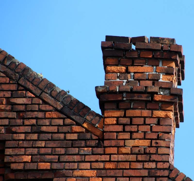 Damaged chimney on an Chicago Heights home showing cracks and missing mortar